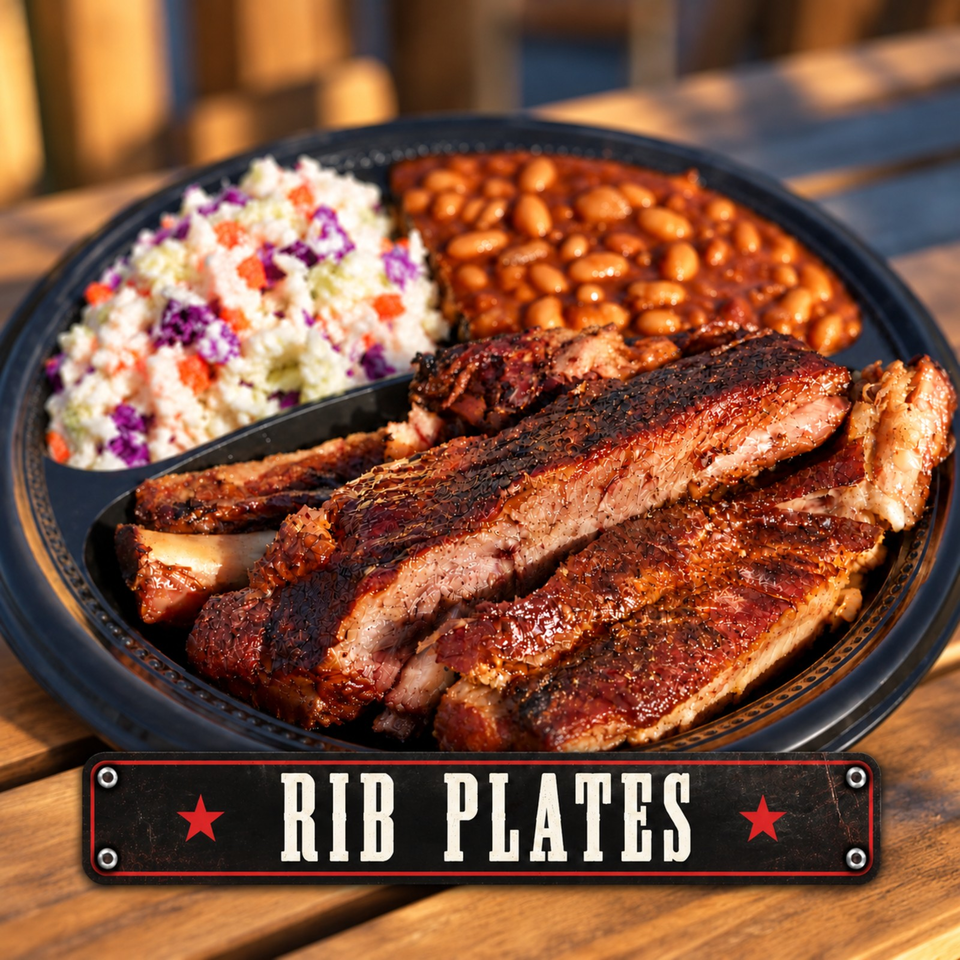 Platter of glazed barbecue ribs served with baked beans and colorful coleslaw on a wooden table.